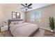 Staged bedroom with queen bed, stylish furnishings, and a large window for natural light at 1512 Groom Ave, North Las Vegas, NV 89081