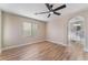 Bedroom with wood-look flooring, neutral paint, ceiling fan, and attached bathroom at 1512 Groom Ave, North Las Vegas, NV 89081