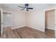Bright bedroom features wood-look flooring, ceiling fan, neutral paint, and an attached walk-in closet at 1512 Groom Ave, North Las Vegas, NV 89081
