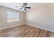 Well-lit bedroom features wood-look flooring and a large window offering plenty of natural light at 1512 Groom Ave, North Las Vegas, NV 89081