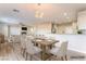 Bright dining room with modern chandelier, wood floors, and a view to the living area at 1512 Groom Ave, North Las Vegas, NV 89081