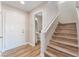 Entryway with staircase, wood-look floors, and a view into powder room at 1512 Groom Ave, North Las Vegas, NV 89081