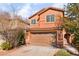 Charming two-story home featuring desert landscaping, a two-car garage, and a welcoming front entrance at 1512 Groom Ave, North Las Vegas, NV 89081