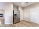 The open-concept kitchen features a stainless steel refrigerator and backyard access at 1512 Groom Ave, North Las Vegas, NV 89081