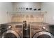 The functional laundry room showcases modern LG machines, a wire rack, and decorative jars at 1512 Groom Ave, North Las Vegas, NV 89081