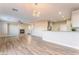 Spacious living area with wood-look flooring, modern lighting, and easy access to the kitchen at 1512 Groom Ave, North Las Vegas, NV 89081