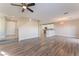 Bright and airy living room features wood-look flooring and an open floor plan to the kitchen and dining area at 1512 Groom Ave, North Las Vegas, NV 89081