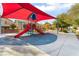 Community playground featuring colorful play structures, picnic benches, and shaded areas for outdoor enjoyment at 1512 Groom Ave, North Las Vegas, NV 89081