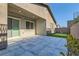 Back patio with stone pavers, a covered sitting area, and a synthetic lawn with a built-in putting green at 157 Sarabeth St, Las Vegas, NV 89138