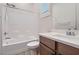 Bright bathroom featuring a single sink, wood cabinets, and tiled shower/tub at 157 Sarabeth St, Las Vegas, NV 89138