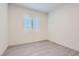Bedroom featuring light colored wood floors and natural light from a plantation shutter window at 157 Sarabeth St, Las Vegas, NV 89138
