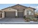 Charming home featuring a three-car garage, low-maintenance landscaping, and a welcoming exterior at 157 Sarabeth St, Las Vegas, NV 89138
