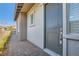 Inviting entryway showcasing a gray front door with brick walkway, complemented by stylish exterior finishes at 157 Sarabeth St, Las Vegas, NV 89138