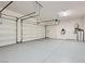 Spacious three-car garage with epoxy flooring, storage racks, and an electric car charging outlet at 157 Sarabeth St, Las Vegas, NV 89138