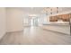 Spacious living room with gray hardwood floors, connecting to the kitchen for seamless entertaining at 157 Sarabeth St, Las Vegas, NV 89138
