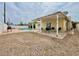 Private backyard featuring a sparkling pool, patio area, and low-maintenance desert landscaping at 1628 Patricia St, North Las Vegas, NV 89030