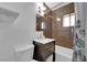 Bathroom featuring vanity with sink, toilet, tub, and shower at 1628 Patricia St, North Las Vegas, NV 89030
