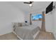 Well-lit bedroom with a modern decor, a ceiling fan, and a flat-screen television at 1628 Patricia St, North Las Vegas, NV 89030