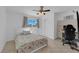 Bright bedroom featuring neutral walls, a ceiling fan, and a sunny window at 1628 Patricia St, North Las Vegas, NV 89030
