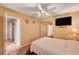 Cozy bedroom with ceiling fan, tv, and closet; offers a serene and comfortable living space at 1721 Derbyshire Dr, Las Vegas, NV 89117