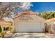 Charming single-story home featuring a terracotta tile roof and a two-car garage at 1721 Derbyshire Dr, Las Vegas, NV 89117