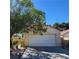 Charming single-story home featuring a two-car garage and a well-manicured front yard with desert landscaping at 1721 Derbyshire Dr, Las Vegas, NV 89117