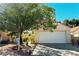 Charming single-story home featuring a well-manicured front yard and a two-car garage at 1721 Derbyshire Dr, Las Vegas, NV 89117