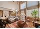 Bright living room with high ceilings, neutral paint, large windows and cozy seating at 1721 Derbyshire Dr, Las Vegas, NV 89117