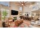 Spacious living room with high ceilings, a fireplace, and seamless flow to the dining area at 1721 Derbyshire Dr, Las Vegas, NV 89117