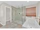 Modern bathroom featuring a glass-enclosed shower and a soaking tub for relaxing at 1808 Michael Ct, Henderson, NV 89014