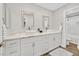 Bathroom with dual sinks, quartz countertops, white cabinets, and a shower over tub at 1808 Michael Ct, Henderson, NV 89014