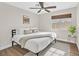 Cozy bedroom featuring a modern ceiling fan, wood floors, and a large window for natural light at 1808 Michael Ct, Henderson, NV 89014