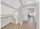 Bright hallway with wood floors leading to a bedroom with ceiling fan and natural light at 1808 Michael Ct, Henderson, NV 89014