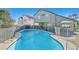 Backyard pool with a safety fence and beautiful landscaping, perfect for outdoor relaxation at 1808 Michael Ct, Henderson, NV 89014