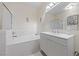 Bright bathroom with soaking tub, modern vanity, and a large mirror at 2050 W Warm Springs Rd # 224, Henderson, NV 89014