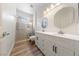 Bright bathroom featuring double sinks and a glass shower at 2050 W Warm Springs Rd # 224, Henderson, NV 89014
