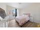 Bedroom with a bed, wooden floors and bright natural light at 2050 W Warm Springs Rd # 224, Henderson, NV 89014