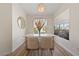 Elegant dining area with modern table, stylish chairs, chic lighting, and a view of the outdoors at 2050 W Warm Springs Rd # 224, Henderson, NV 89014