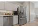 Bright kitchen featuring white cabinets, granite countertops, stainless steel appliances, and tile flooring at 2050 W Warm Springs Rd # 224, Henderson, NV 89014