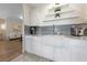 Charming kitchen featuring a farmhouse sink, white cabinets, and open shelving at 2050 W Warm Springs Rd # 224, Henderson, NV 89014