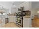 Well-equipped kitchen features stainless steel appliances, white cabinets, tile backsplash, and granite countertops at 2050 W Warm Springs Rd # 224, Henderson, NV 89014