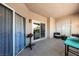 Covered patio with tile flooring features outdoor seating and sliding glass doors leading to the interior at 2050 W Warm Springs Rd # 224, Henderson, NV 89014