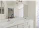 Bright bathroom featuring double sinks, white cabinetry, and large mirror at 2080 Silver Breeze Ave, Las Vegas, NV 89183