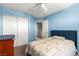 Light-filled bedroom featuring a bed, soft blue walls, and a spacious closet at 2080 Silver Breeze Ave, Las Vegas, NV 89183