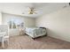 Bedroom with bright window and shade, carpet floor, ceiling fan and furniture at 2080 Silver Breeze Ave, Las Vegas, NV 89183