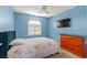 Bright bedroom featuring a shuttered window and dresser with blue walls at 2080 Silver Breeze Ave, Las Vegas, NV 89183