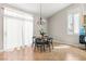 Bright dining area with a modern chandelier, neutral walls, tile flooring, and a large window at 2080 Silver Breeze Ave, Las Vegas, NV 89183
