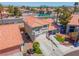 Charming two-story home featuring a terracotta-tiled roof and a well-manicured front yard with green grass and shrubs at 2080 Silver Breeze Ave, Las Vegas, NV 89183