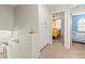 Hallway with carpeted floors and white walls leading to two bedrooms in the home at 2080 Silver Breeze Ave, Las Vegas, NV 89183