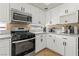 Modern kitchen with white cabinets, stainless steel appliances, granite countertops, and tile backsplash at 2080 Silver Breeze Ave, Las Vegas, NV 89183